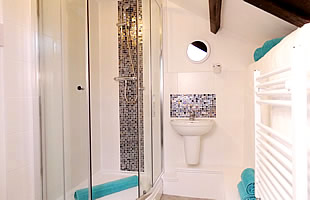Bathroom with shower cubicle, washbasin and wc